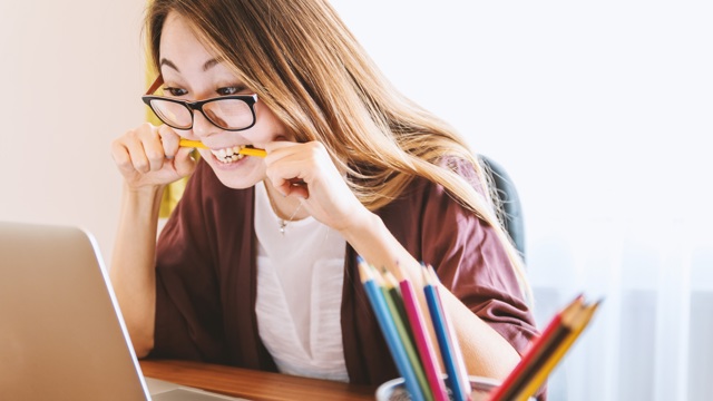 Woman on laptop choosing between a personal loan from Instant Finance and BNPL through Afterpay