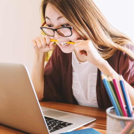 Woman on laptop choosing between a personal loan from Instant Finance and BNPL through Afterpay