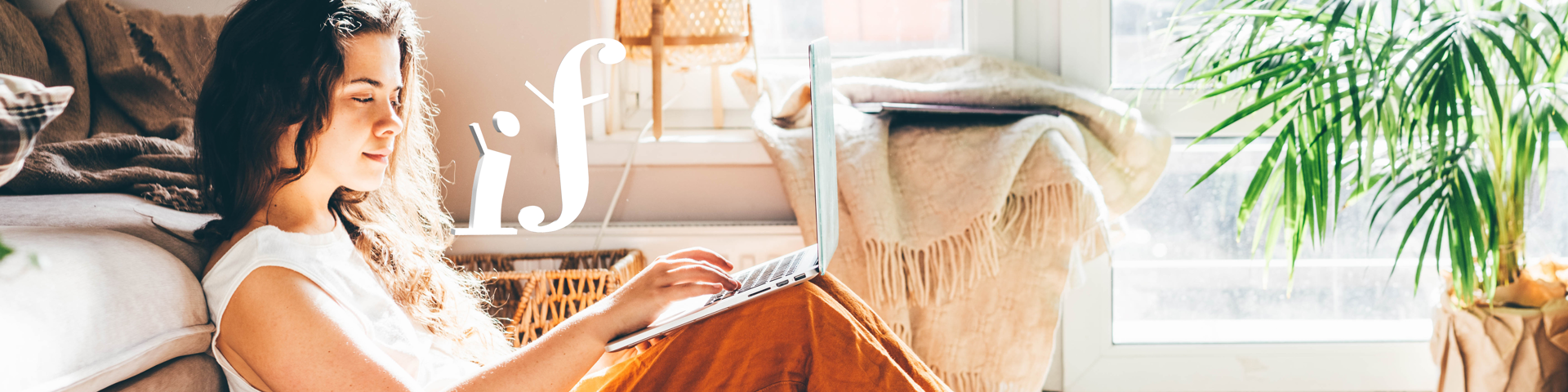 Girl sitting in her bedroom working on laptop