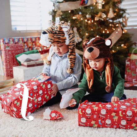 tow cute kids opening Christmas presents