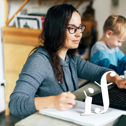 Woman on laptop doing research on personal loan eligibility. 