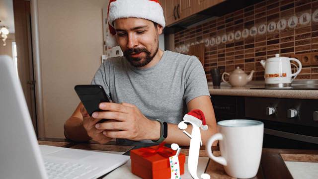 Man in santa hat using phone and laptop, sitting next to I and F characters from Instant Finance