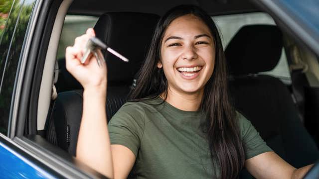 Instant Finance Car Loan. Woman holding keys to new car