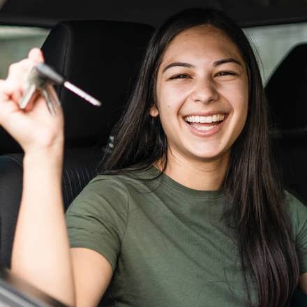 Instant Finance Car Loan. Woman holding keys to new car