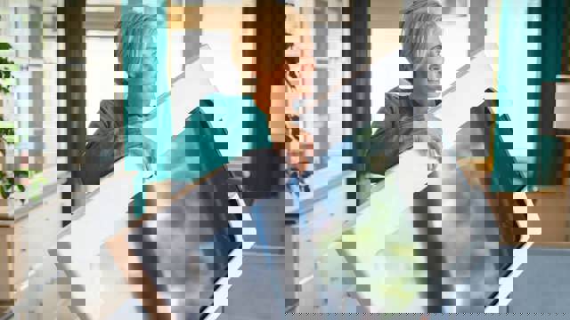 Instant Finance Cash Loans. Woman holding a new Television (Tv)