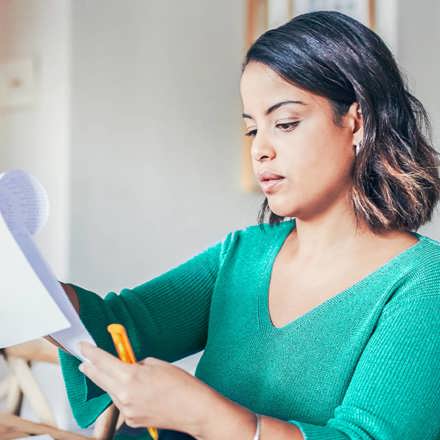 Instant Finance Debt Consolidation Loan. Woman holding a piece of paper and pen