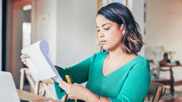 Instant Finance Debt Consolidation Loan. Woman holding a piece of paper and pen