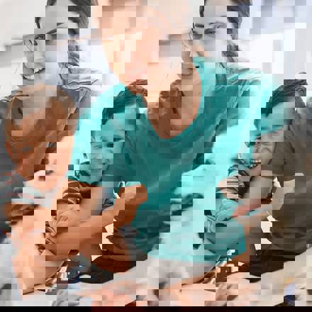 Instant Finance How to get a loan. Woman with son and dog looking at a laptop computer