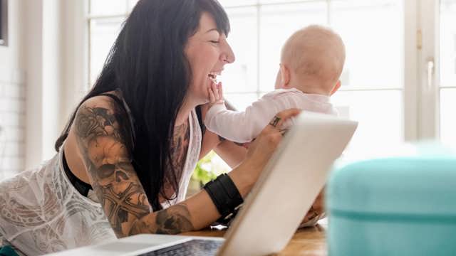 Instant Finance Life Event Loan. Woman holding Baby