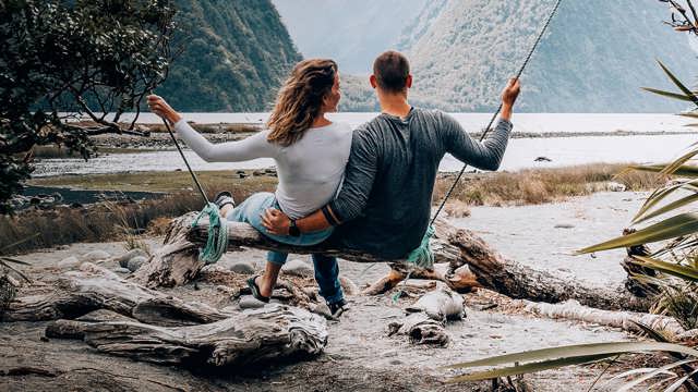 Instant Finance Personal Loans. Man and Woman on a Swing