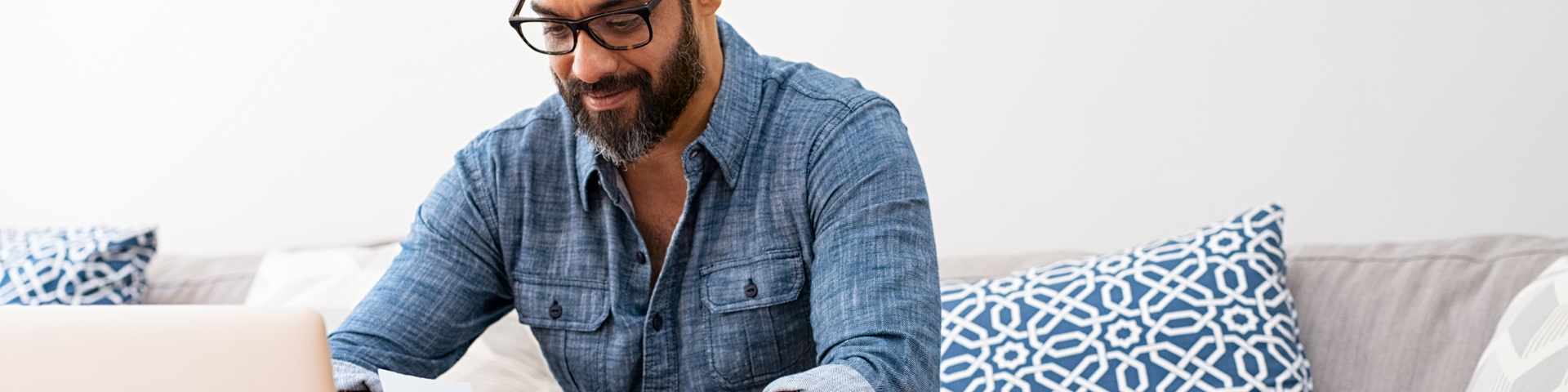 Man on laptop computer looking at his financial health