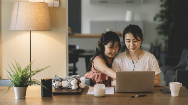 Woman on a computer with her daughter applying for personal student loans