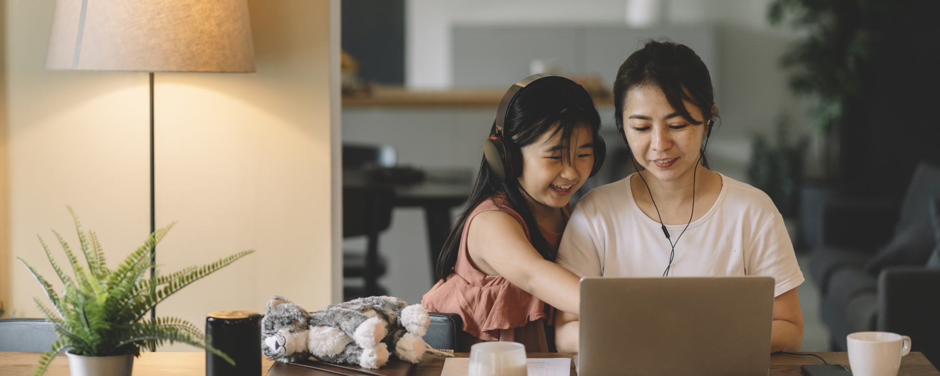 Woman on a computer with her daughter applying for personal student loans