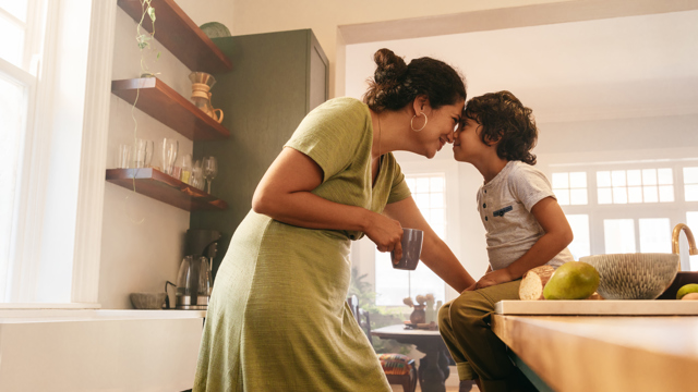 Woman and son in kitchen. Thinking about dental finance nz