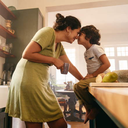 Woman and son in kitchen. Thinking about dental finance nz