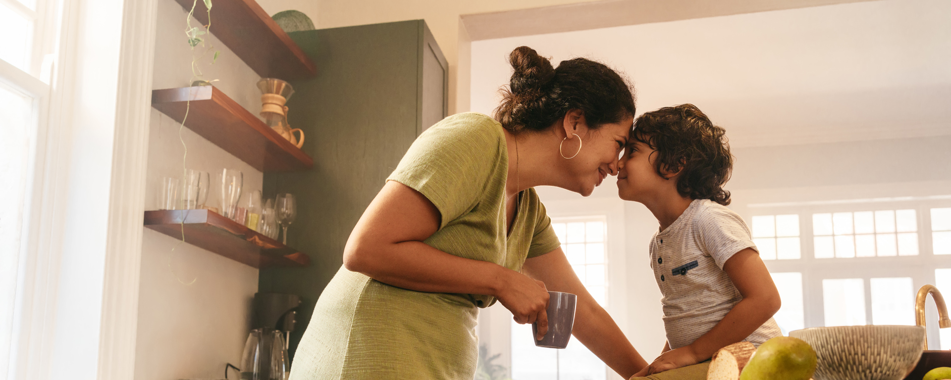 Woman and son in kitchen. Thinking about dental finance nz